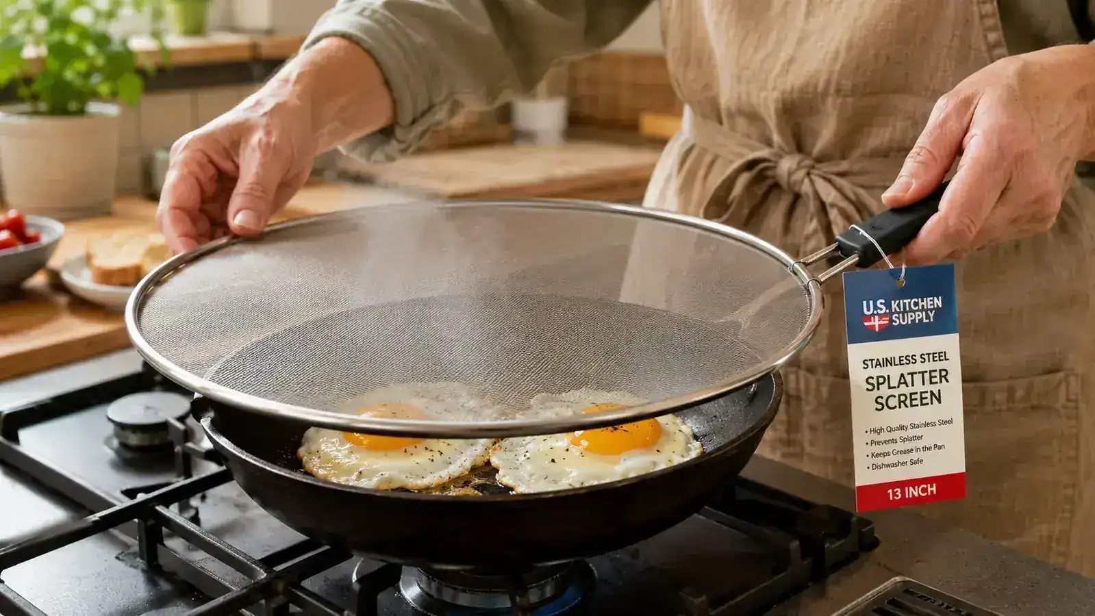 Hand placing a stainless steel mesh splatter screen over a pan of frying eggs