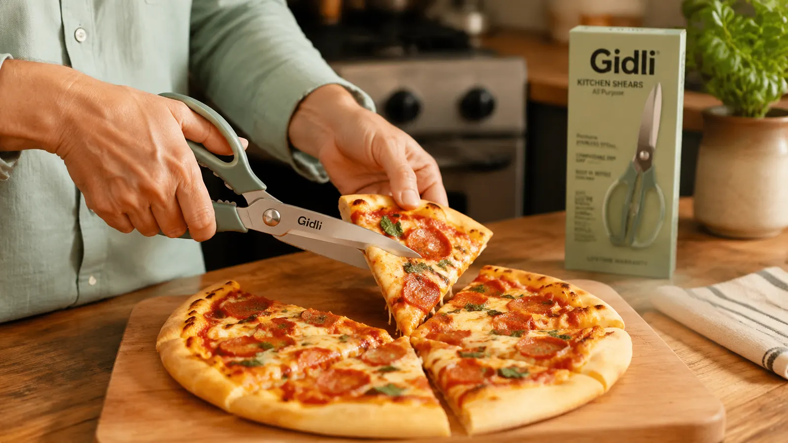 Kitchen shears snipping fresh basil leaves directly over a pot of tomato sauce on the stovetop